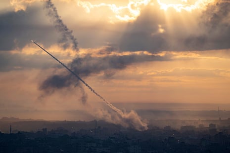 A rocket leaves a smoke trail as it rises through the air