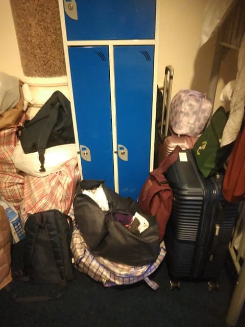 Pile of belongings in a small cramped hotel room qhxidiqxkiqxrinv