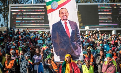 A woman holds a banner with the portrait of Ethiopia’s prime minister Abiy Ahmed during a rally in Addis Ababa