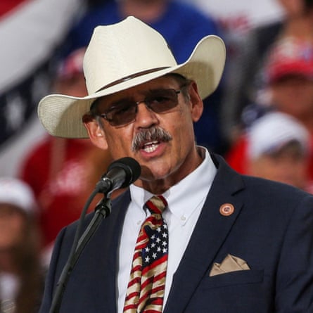 Mark Finchem in a cowboy hat and American flag tie.