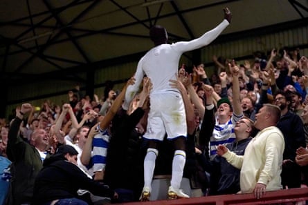 Albert Adomah celebrates with QPR fans after scoring the winning penalty at Leyton Orient in the Carabao Cup this season.