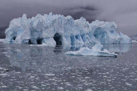 Icebergs calved from the Kangerlussuup glacier rise in the water and reveal caves previously underwater