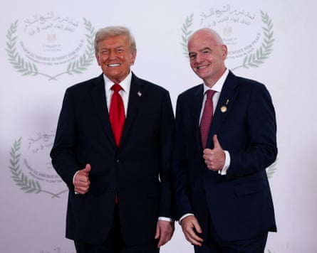 Trump and Infantino pose for a photo giving a thumbs-up