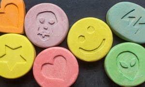 Ecstasy tablets on black background