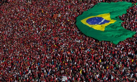 Supporters of Lula display a Brazilian flag during the presidential inauguration ceremony at Planalto Palace in Brasilia.