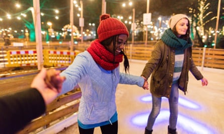 Photo of cheerful friends having fun while ice-skating; personal perspective point of view