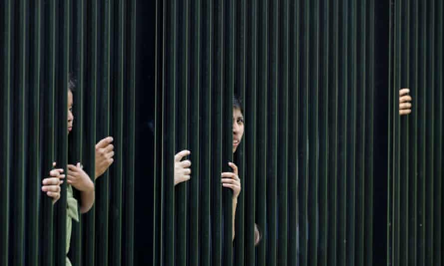 Members of the public watch through the White House fence as they await BTS's arrival.