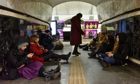 People shelter in a subway station in Kyiv during an air raid alert on Friday