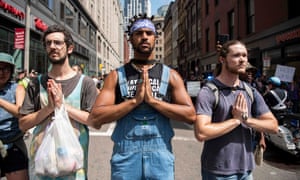 Three counter-protesters pretending to be praying.