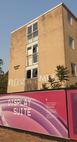 public housing units wrapped by a developer's display suite sign