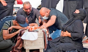 An Iraqi family mourns the coffin of a relative as they return to the huge Wadi al-Salam cemetery in the Shiite holy city of Najaf.