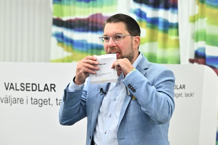 Åkesson licks the envelope of a ballot paper