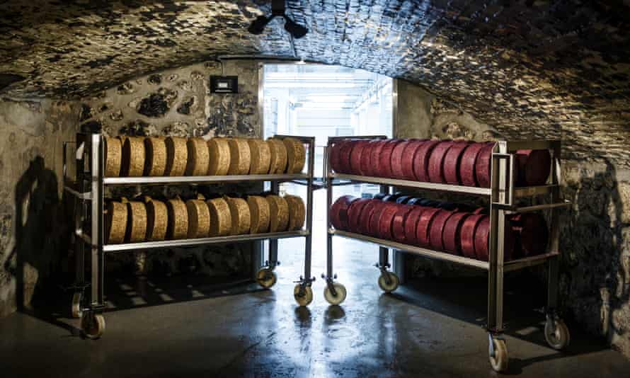 Recently finished wheels of cheese sit on carts in the cheese caves of the Sartori Cheese Company in Plymouth, Wisconsin.