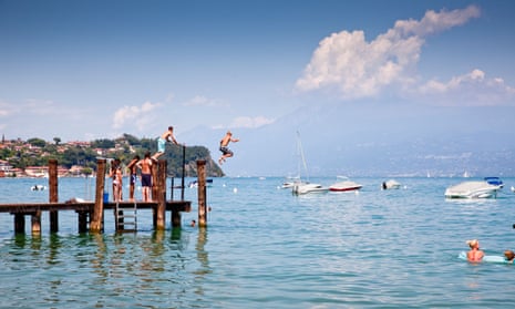 Pier pressure … young people launch themselves into the thermal waters of Lake Garda.