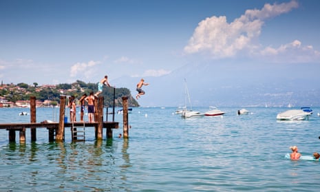 Children jumping into Lake Garda, northern Italy