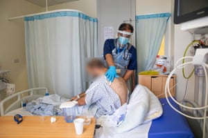 Dr Asad Ali examines an unidentified patient who has participated in plasma trials.