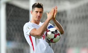 Robert Lewandowski collects the match ball after his hat-trick against Armenia saw him become Poland’s all-time top scorer.