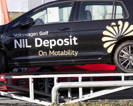 A black VW Golf emblazoned with ‘Nil deposit on Motability’ on its side.