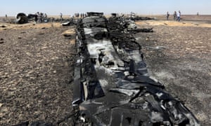 Military investigators from Egypt and Russia stand near the debris of a Russian airliner.