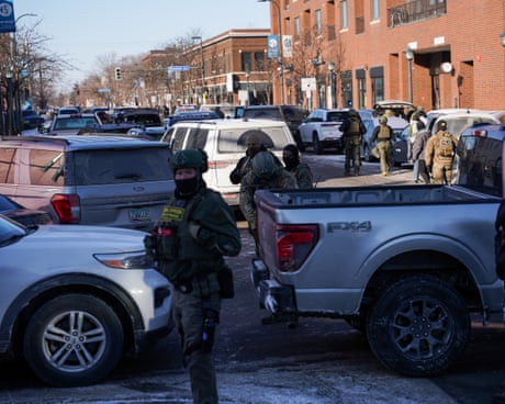 Federal agents stand guard at the scene of the shooting in south Minneapolis, Minnesota, on 24 January 2026.