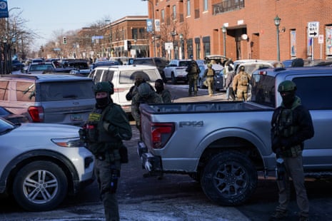 Federal agents stand guard at the scene of the shooting in south Minneapolis, Minnesota, on 24 January 2026.