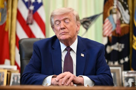 Donald Trump speaks to the press in the Oval Office of the White House.