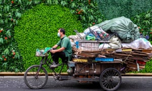 A man rides a tricycle with the garbage in Shanghai, China, 13 July 2020.
