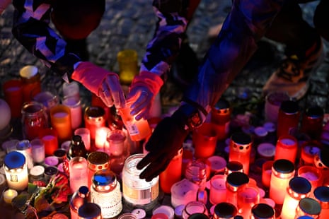 Mourners lay candle lights outside the headquarters of Charles University for victims of mass shooting in Prague, Czech Republic, Friday, Dec. 22, 2023.