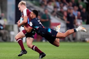 Queensland’s Tom Lynagh is tackled by Glen Vaihu of the Melbourne Rebels during a Super Rugby Pacific match on 15 March. The Reds proved too good on the night, running out 53-26 winners at AAMI Park.