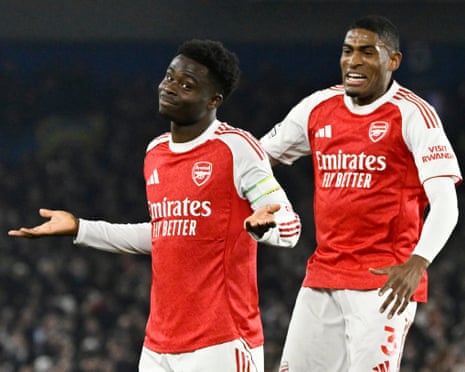 Arsenal's Bukayo Saka (left) celebrates scoring their first goal with Cristhian Mosquera.