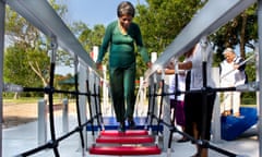 84-year-old Zady Jones walks across a rope step bridge at the senior playground at Carbide Park