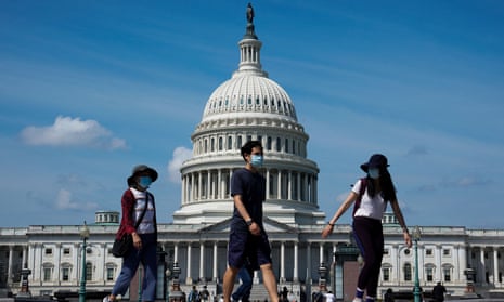 People walk past the US Capitol in Washington DC on 4 September 2022. 