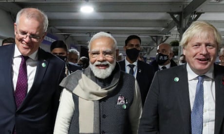 Britain's Prime Minister Boris Johnson, India's Prime Minister Narendra Modi and Australia's Prime Minister Scott Morrison walk together during the UN Climate Change Conference (COP26) in Glasgow, Scotland, Britain, November 2, 2021.