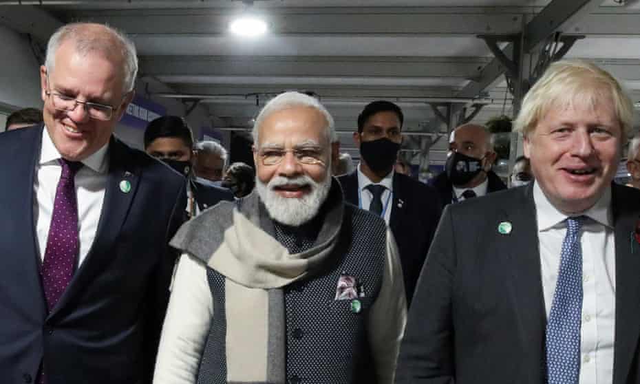 Britain's Prime Minister Boris Johnson, India's Prime Minister Narendra Modi and Australia's Prime Minister Scott Morrison walk together during the UN Climate Change Conference (COP26) in Glasgow, Scotland, Britain, November 2, 2021.