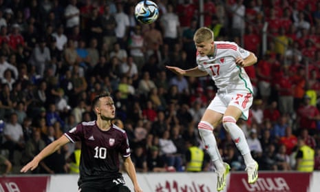 Jordan James (right), climbs to head the ball during Wales’ 2-0 victory in Latvia.