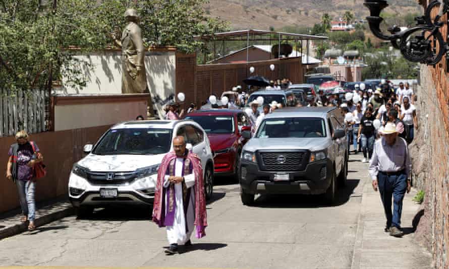 Father Gilberto Vergara leads the funeral procession of César Arturo Valencia Caballero, the mayor of Aguililla who was shot dead while driving home from city hall, in Aguililla last week.