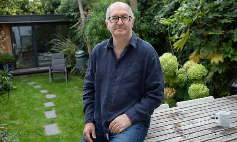 John Lanchester in front of his garden office where he writes, London, September 2020