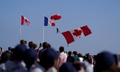 Parachutists in front of Canadian and French flags