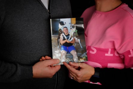 Mugurel and Eugenia holding a picture of Eugen Sabau