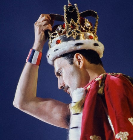 Head and shoulders shot of Mercury clasping ornate crown on his head with red-and-white ermine-style cloak