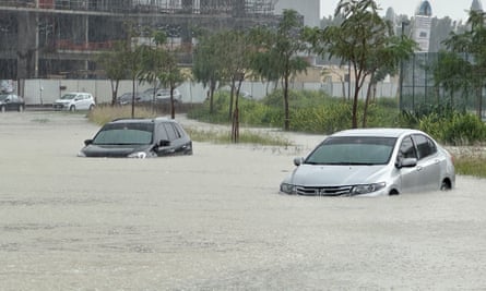 Cars lie half-submerged in a flooded street in Dubai on Tuesday.