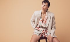 Model wearing shorts and a cream jacket.