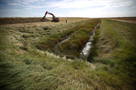 A digger makes adjustments to a levee at the eastern end of Wallasea Island on September 17, 2012 near Rochford, England
