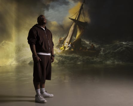 Man stands in an immersive recreation of Rembrandt’s Christ in the Storm, which shows Christ’s disciples battling a fierce storm in a fishing boat.