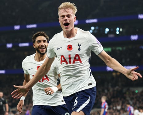 Jan Paul van Hecke celebrates with arms outstretched after scoring, teammate smiling behind him