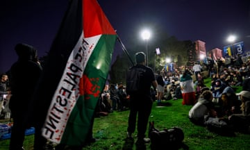 Supporters of the pro-Palestinian protesters sit on stairs leading to an encampment, UCLA campus