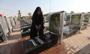 A woman washes the grave of her relative.