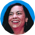 woman smiling and looking to side with blue background