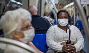 People wear protective masks on the subway in São Paulo, Brazil. 