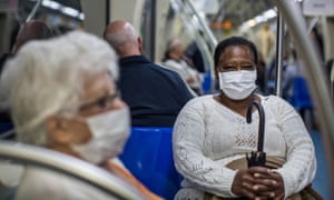 People wear protective masks on the subway in São Paulo, Brazil. People wear protective masks on the subway in São Paulo, Brazil.
